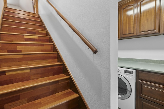 washroom with washer / clothes dryer and cabinets