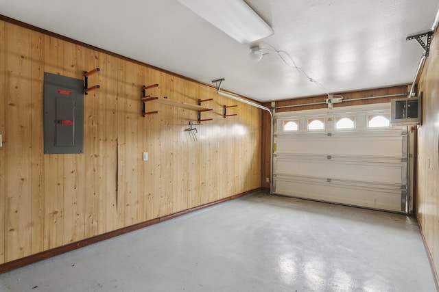 garage with electric panel and wooden walls