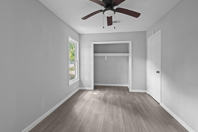 3015 Timberwood Ln, Beaumont, TX 77703 - unfurnished bedroom featuring wood finished floors, baseboards, a closet, and a ceiling fan