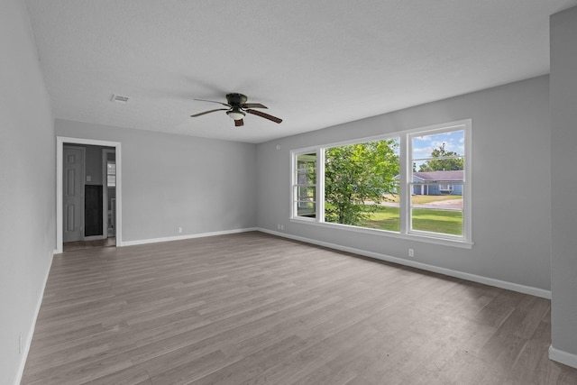 3015 Timberwood Ln, Beaumont, TX 77703 - spare room featuring ceiling fan, wood finished floors, baseboards, and a textured ceiling