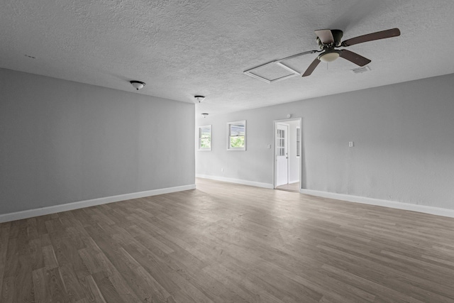 3015 Timberwood Ln, Beaumont, TX 77703 - unfurnished room with attic access, wood finished floors, a textured ceiling, and baseboards