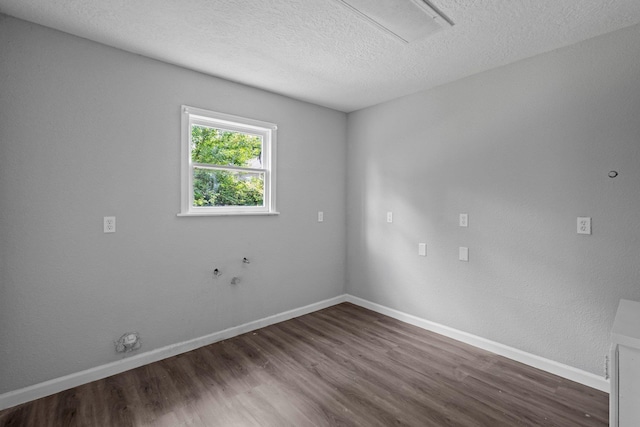 3015 Timberwood Ln, Beaumont, TX 77703 - spare room with dark wood finished floors, a textured ceiling, baseboards, and attic access
