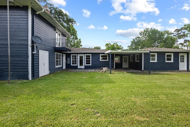 3015 Timberwood Ln, Beaumont, TX 77703 - rear view of house with a lawn, a patio area, and a balcony