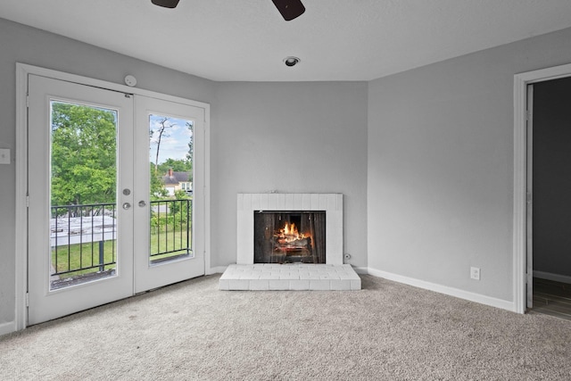 3015 Timberwood Ln, Beaumont, TX 77703 - unfurnished living room with french doors, carpet, a ceiling fan, a fireplace, and baseboards