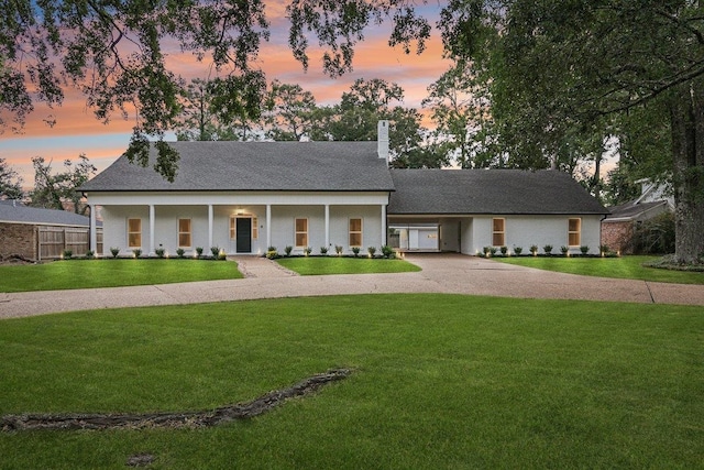 view of front of house featuring a lawn and a porch