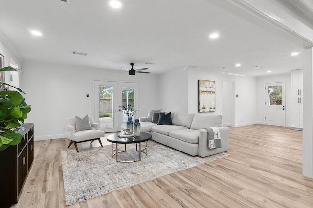 living room with ceiling fan, ornamental molding, light hardwood / wood-style flooring, and french doors