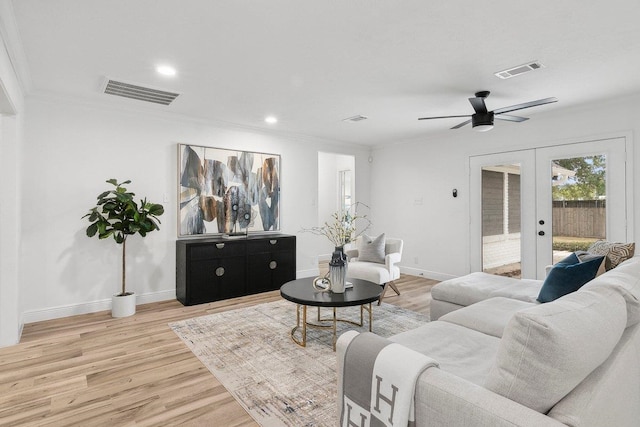 living room with ceiling fan, french doors, crown molding, and hardwood / wood-style flooring