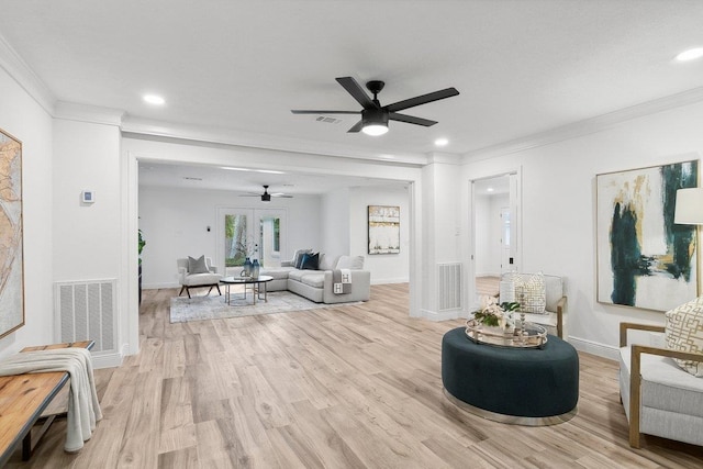 living room with ceiling fan, light hardwood / wood-style flooring, french doors, and ornamental molding