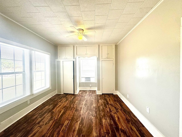 unfurnished bedroom with dark wood-type flooring, cooling unit, and ceiling fan