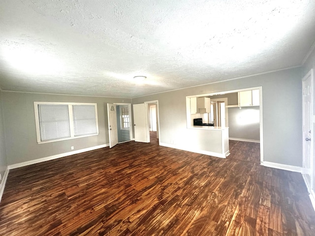 unfurnished living room with dark wood-type flooring and a textured ceiling