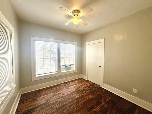 unfurnished bedroom with dark hardwood / wood-style flooring, cooling unit, ceiling fan, and a closet