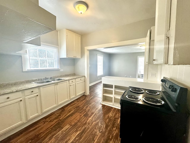 kitchen with sink, light stone counters, electric range, dark hardwood / wood-style flooring, and white cabinets