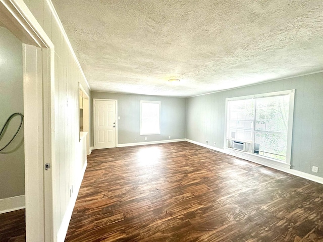 spare room with crown molding, wooden walls, and dark hardwood / wood-style floors