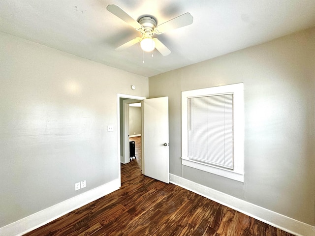 unfurnished bedroom with dark hardwood / wood-style flooring and ceiling fan