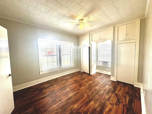 unfurnished bedroom with dark hardwood / wood-style flooring and ceiling fan