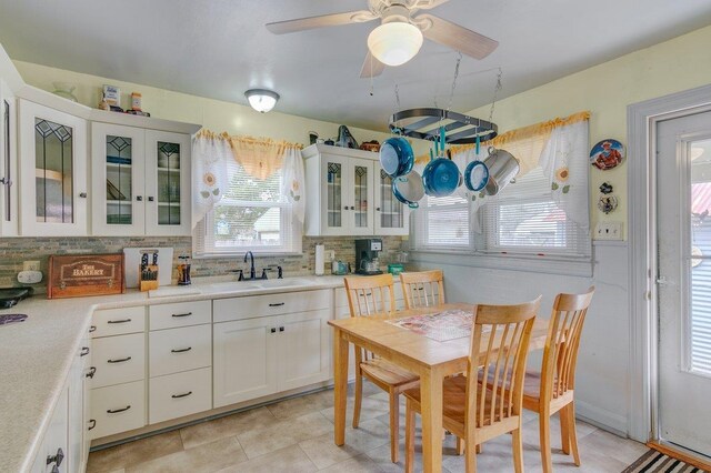 kitchen featuring backsplash, sink, and white cabinets