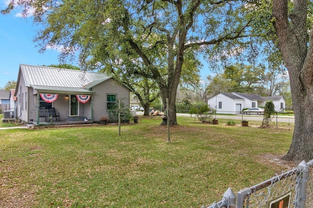 view of yard featuring covered porch and central AC unit