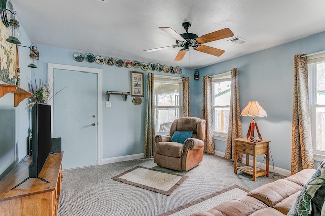 carpeted living room with ceiling fan and a healthy amount of sunlight