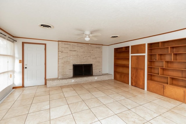 unfurnished living room with a brick fireplace, light tile patterned floors, a textured ceiling, and ceiling fan