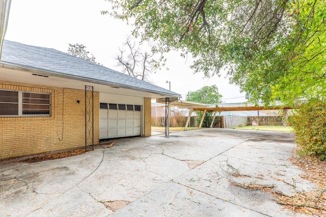 view of patio featuring a garage and a carport