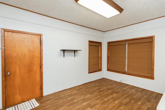 unfurnished room with hardwood / wood-style flooring