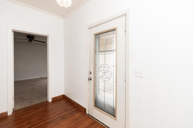 entrance foyer with an inviting chandelier, ornamental molding, and dark hardwood / wood-style floors