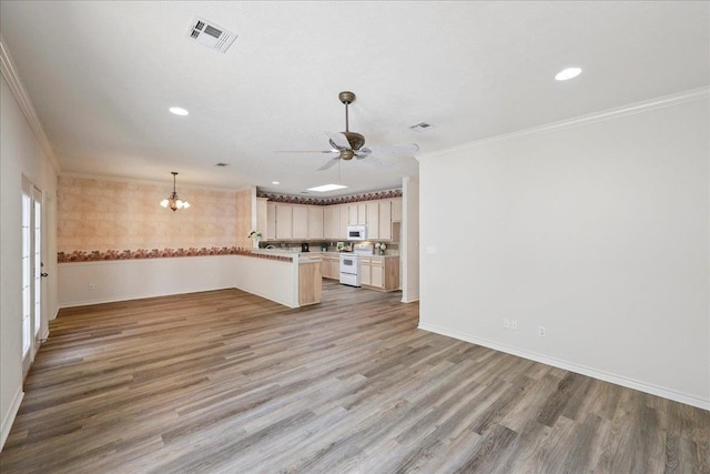 8076 Indian Blanket Dr, Beaumont, TX 77713 - unfurnished living room featuring ornamental molding, light wood-type flooring, a ceiling fan, a chandelier, and recessed lighting