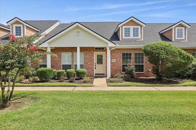 8076 Indian Blanket Dr, Beaumont, TX 77713 - view of front of house with a front yard, roof with shingles, and brick siding