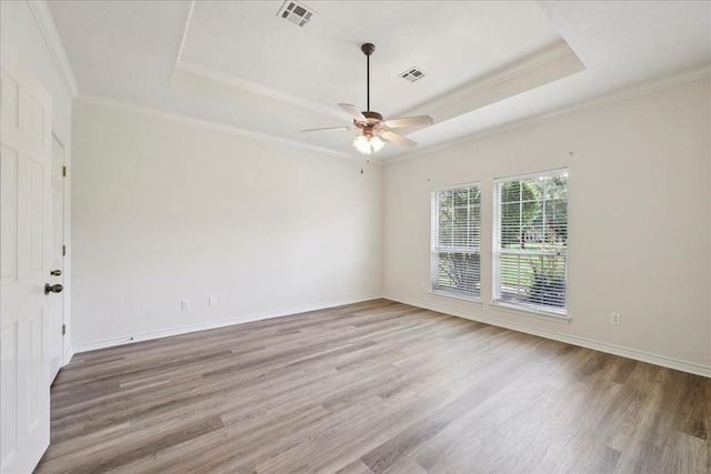 8076 Indian Blanket Dr, Beaumont, TX 77713 - unfurnished room with a raised ceiling, light wood-style flooring, ceiling fan, and crown molding