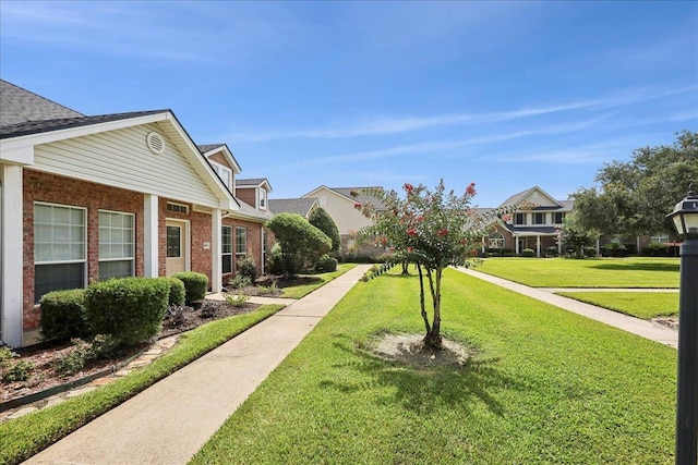8076 Indian Blanket Dr, Beaumont, TX 77713 - surrounding community featuring a lawn and a residential view