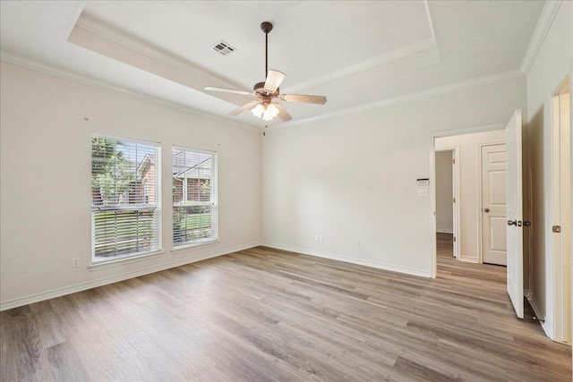 8076 Indian Blanket Dr, Beaumont, TX 77713 - unfurnished room with a raised ceiling, light wood-type flooring, crown molding, and a ceiling fan