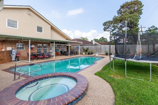 915 S 23rd St, Nederland, TX 77627 - view of swimming pool featuring a fenced in pool, a fenced backyard, a patio area, a trampoline, and an in ground hot tub
