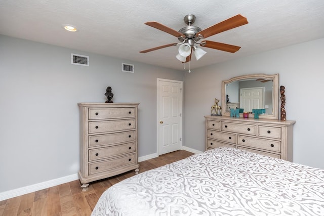 915 S 23rd St, Nederland, TX 77627 - bedroom with baseboards, wood finished floors, and visible vents