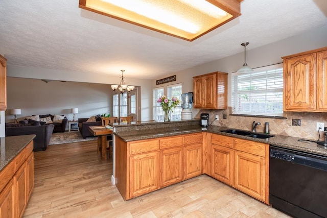 915 S 23rd St, Nederland, TX 77627 - kitchen with a wealth of natural light, a peninsula, a sink, and black dishwasher
