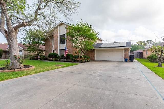 915 S 23rd St, Nederland, TX 77627 - mid-century inspired home featuring solar panels, brick siding, driveway, and a front lawn