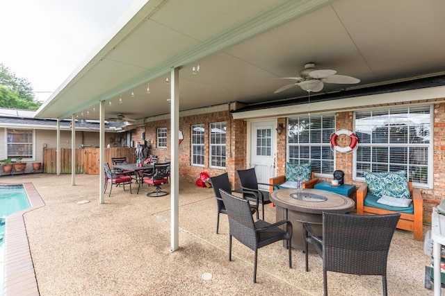 915 S 23rd St, Nederland, TX 77627 - view of patio / terrace with a fenced in pool, a fire pit, fence, a ceiling fan, and outdoor dining area