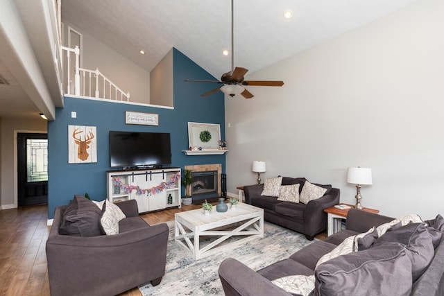 915 S 23rd St, Nederland, TX 77627 - living room featuring baseboards, a ceiling fan, wood finished floors, a fireplace, and high vaulted ceiling