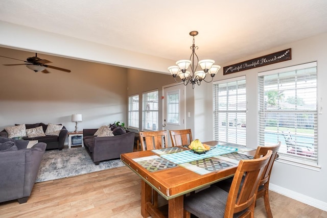 915 S 23rd St, Nederland, TX 77627 - dining room with light wood-type flooring, baseboards, and ceiling fan with notable chandelier