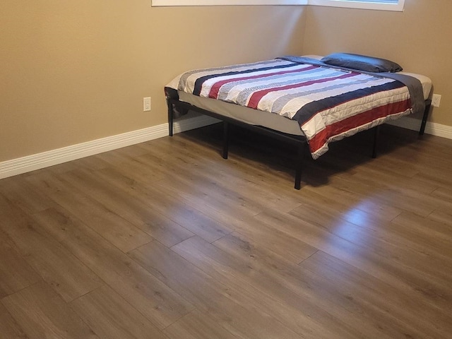 bedroom with wood-type flooring