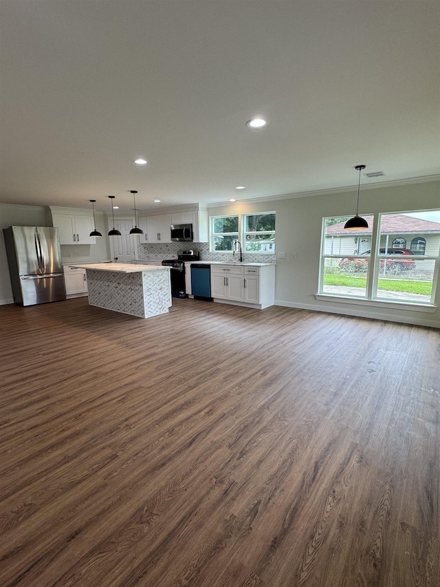 3128 58th St, Port Arthur, TX 77640 - kitchen featuring appliances with stainless steel finishes, white cabinets, dark wood-style floors, recessed lighting, and backsplash