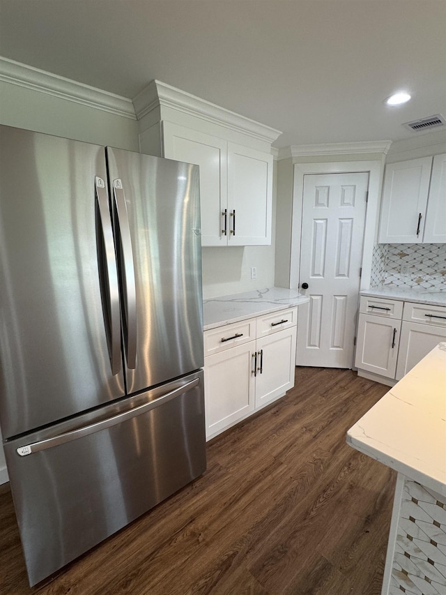 3128 58th St, Port Arthur, TX 77640 - kitchen with freestanding refrigerator, dark wood-type flooring, white cabinets, ornamental molding, and recessed lighting