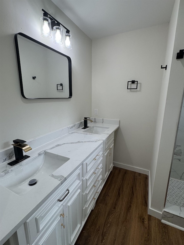 3128 58th St, Port Arthur, TX 77640 - bathroom featuring wood finished floors, double vanity, and a walk in shower