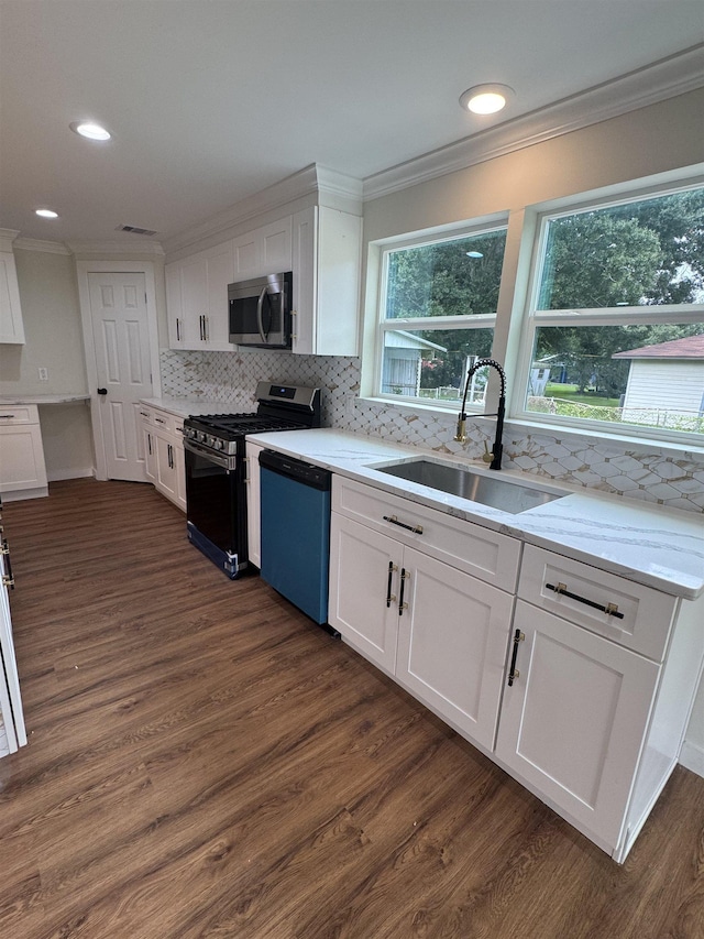 3128 58th St, Port Arthur, TX 77640 - kitchen featuring gas range oven, stainless steel microwave, dishwashing machine, crown molding, and white cabinets