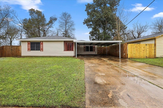 ranch-style home with concrete driveway, a gate, fence, an attached carport, and a front lawn