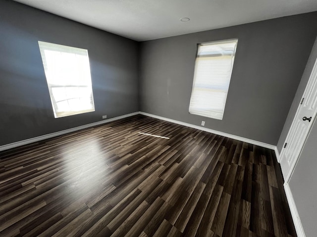 spare room featuring dark hardwood / wood-style flooring