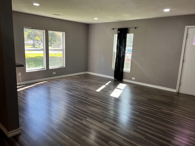 spare room featuring dark wood-type flooring