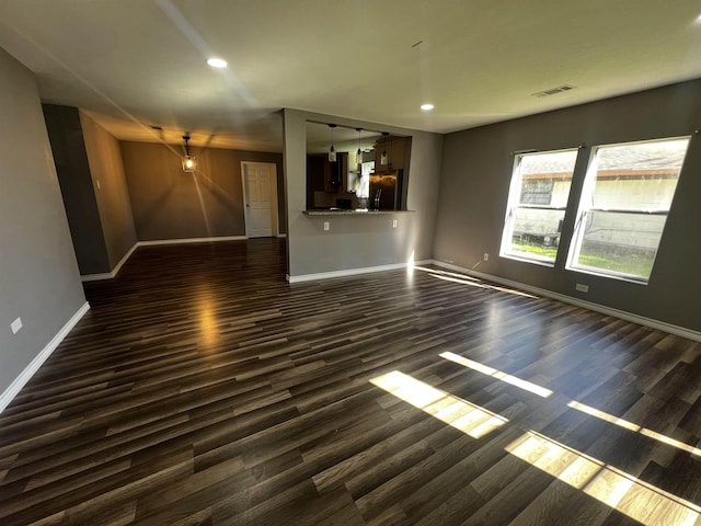 unfurnished living room with dark hardwood / wood-style floors