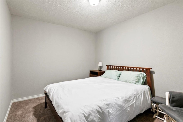 carpeted bedroom with a textured ceiling