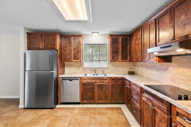 kitchen with sink, light stone countertops, light tile patterned floors, appliances with stainless steel finishes, and tasteful backsplash