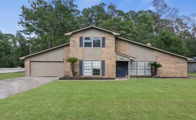 front facade featuring a garage and a front lawn